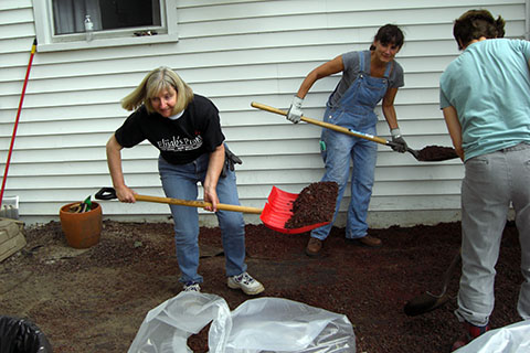The Rev. Sheelagh Clarke and parishioners clean up after Hurricane Irene