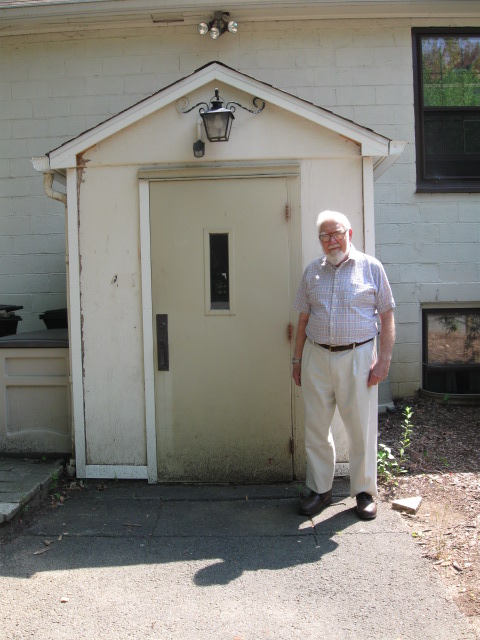 Leroy May standing outside All Saints' Church, Millington.