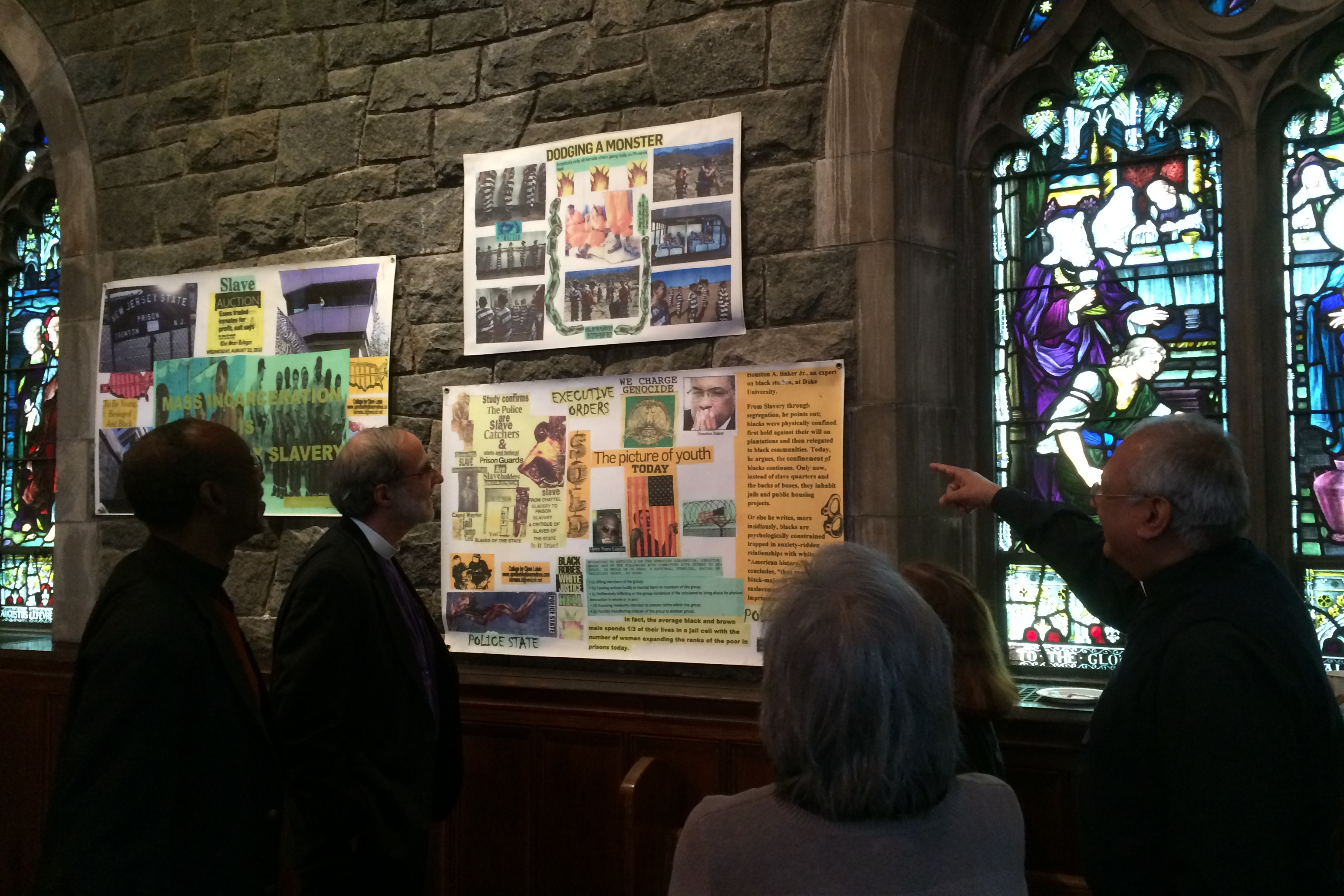 Bishop Mark Beckwith and others view artwork by Ojore Nuru Lutalo