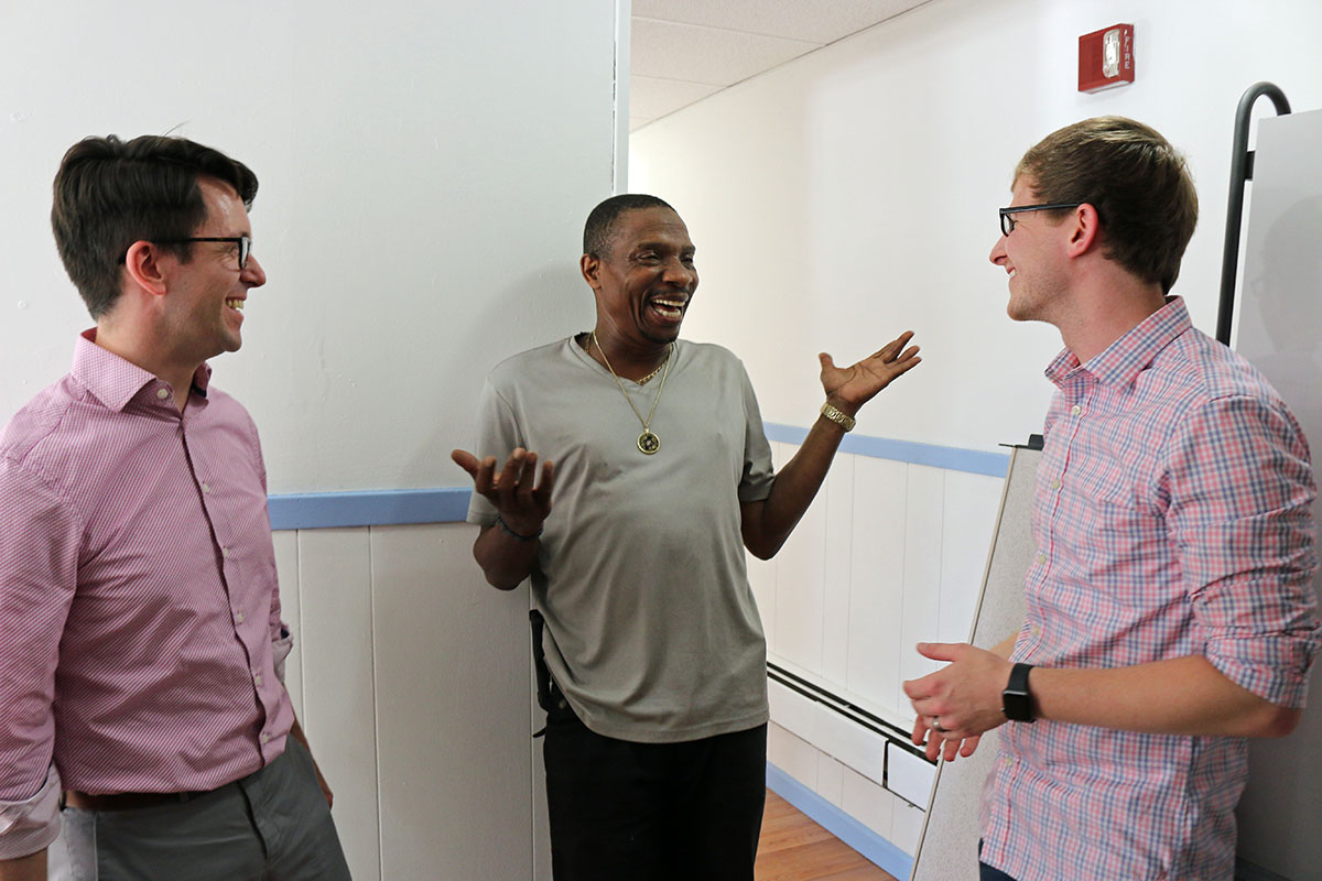 Christopher Jennings and Chris Whitaker talk with Tommy Lovett (center), House of Prayer's sexton. Lovett helped facilitate the renovation of the classroom space, and plans to be in the first group of students. NINA NICHOLSON PHOTO