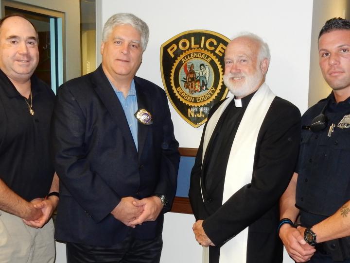 The Rev. Michael Allen with Allendale police chief Gerge Scherb and two officers