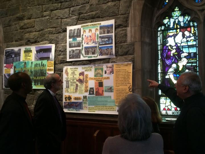 Bishop Mark Beckwith and others view artwork by Ojore Nuru Lutalo