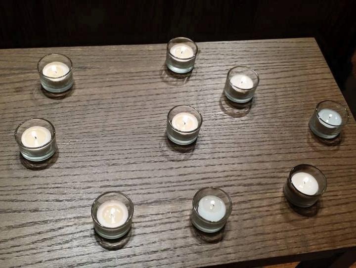 Nine votive candles representing Charleston shooting victims