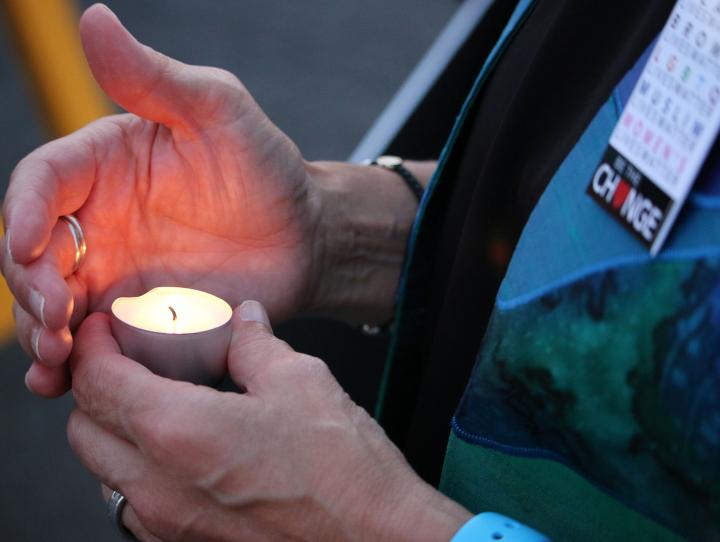 The Rev. Diana Wilcox holds a candle at the Lights for Liberty vigil outside the immigration detention center in Elizabeth. NINA NICHOLSON PHOTO