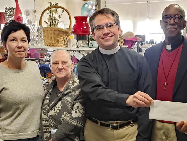 The Rev. Jerry Racioppi of Holy Spirit, Verona and volunteers of Heavenly Finds Thrift Shop give a donation from the shop's proceeds to the Rev. Deacon Peter Jackson and the Rev. Dr. Miguel Hernandez of Holy Trinity, West Orange for Christine's Kitchen.