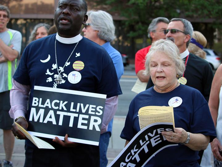 Members of the Diocese of South Carolina wearing T-shirts with nine doves