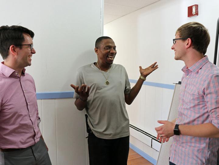 Christopher Jennings and Chris Whitaker talk with Tommy Lovett (center), House of Prayer's sexton. Lovett helped facilitate the renovation of the classroom space, and plans to be in the first group of students. NINA NICHOLSON PHOTO