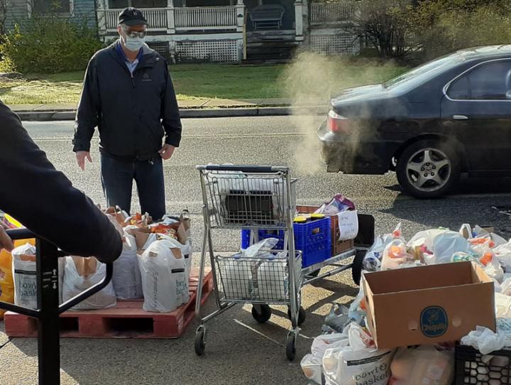 Volunteers distribute bags of food to cars lined up in front of St. Agnes, Little Falls. PHOTO COURTESY BOB DOMBROWSKI