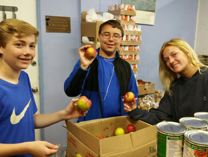 Mission trip participants package apples