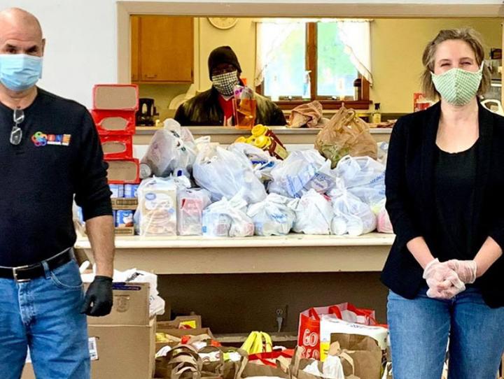 The Rev. Rod Perez-Vega (right) accepts a donation of food from a State Senate candidate, who ran a food drive as part of her campaign. PHOTO SOURCE: FACEBOOK