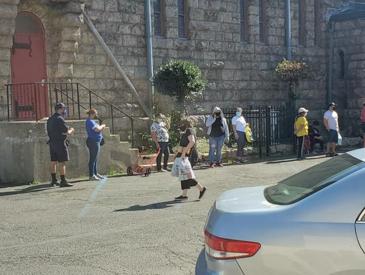 Clients line up outside the food pantry at St. Paul's, Paterson. ERIK SOLDWEDEL PHOTO