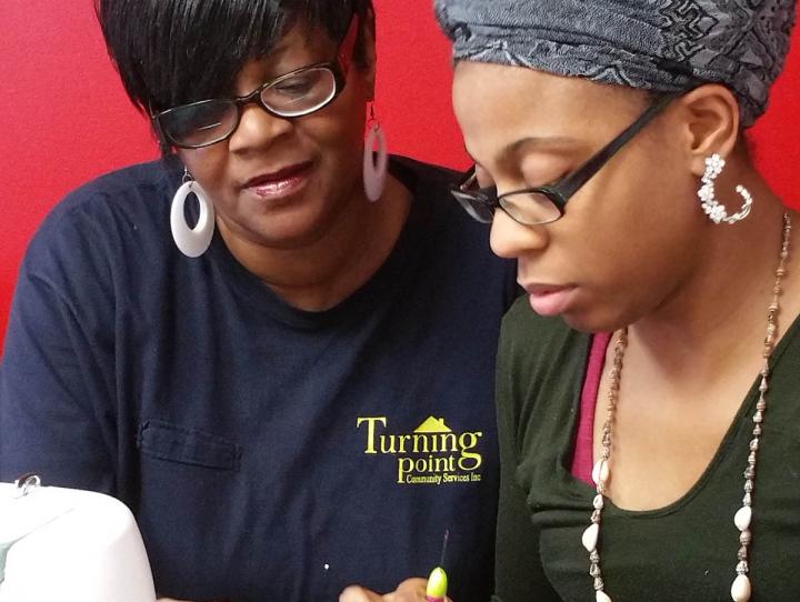 Jeanette teaching sewing in the TPCS, Inc. peer training program.