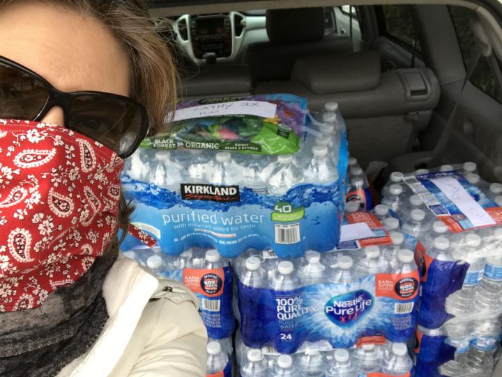 Author Birgitta Karlen with a trunk full of bottled water ready to be delivered to a local hospital.