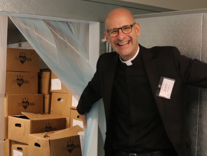The Rev. John Mennell of St. Luke's, Montclair shows off the new walk-in refrigerator, part of the $1.2 million renovation of the church's undercroft to expand the ministry of Toni's Kitchen. NINA NICHOLSON PHOTO