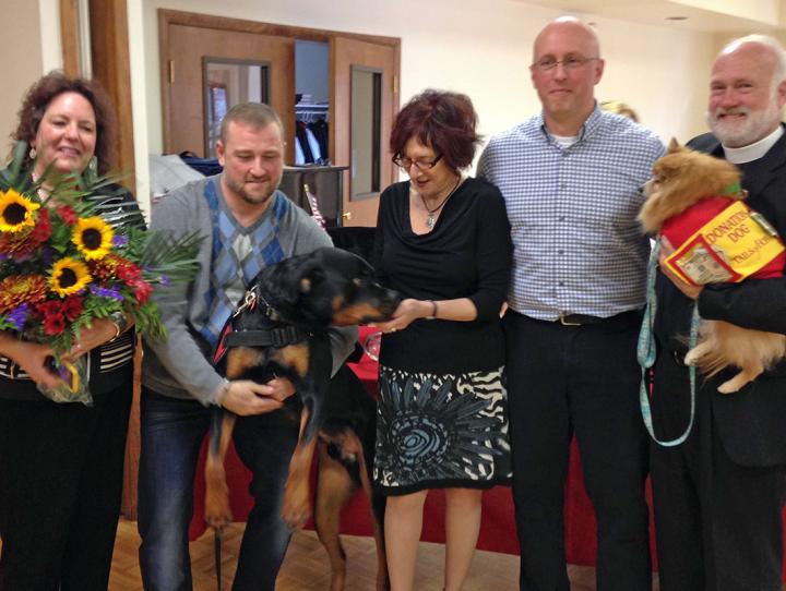 SSgt. David Kist and his service dog Patrick, with members of Trinity, Allendale