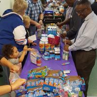 Volunteers formed two assembly lines to package "snack packs" for school children of Teaneck. JAMES PORTER PHOTO