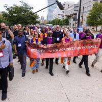 Bishops United Against Gun Violence led a march to and vigil at the site of a homicide two blocks from the convention center where the 80th General Convention of the Episcopal Church was being held.