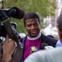 Bishop Eugene Sutton, Bishop of Maryland, speaks to the media following a vigil organized by Bishops United Against Gun Violence at the site of a homicide.