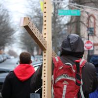 A participant carries the cross.