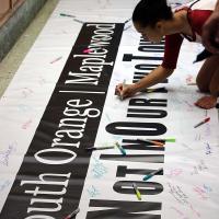 Attendees were asked to sign two banners, one for each town.