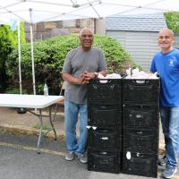 Jeffrey Johnson of St. Paul's and Pedro Besonia of DCVYP setting up the curbside pickup. NINA NICHOLSON PHOTO