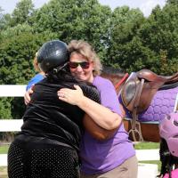 Colleen Wolfe, Program Director of Haven of Hope for Kids, hugs the mother after her turn.