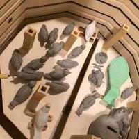 Birds made by Kathie Maglio and other artwork created by her students await firing in her kiln. The spoon rest is green because it is covered with clear glaze to make the colors underneath glossy.