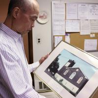 Gary Eng looks at a photo of the original St. Paul's building, built in 1914 and destroyed by fire in 1978. NINA NICHOLSON PHOTO