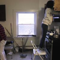 Volunteers clean The Lighthouse's kitchen.