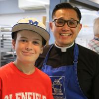 The Rev. Tristan Shin with the youngest volunteer at Toni's Kitchen.