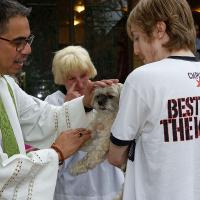 The Rev. Gregory Perez blesses pets at Trinity, Bayonne. PHIL BENSON PHOTO