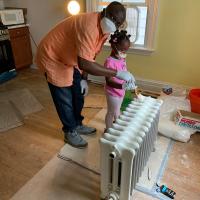 The Rev. Sylvester Ekunwe, formerly of St. Andrew's, Newark, brought his daughter to  join the mission "trip" to paint the house. PHOTO COURTESY ST. PETER'S, MOUNTAIN LAKES