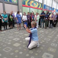 Diana Wilcox photographs participants in Purple Scarf Day at General Convention. SHARON HAUSMAN PHOTO
