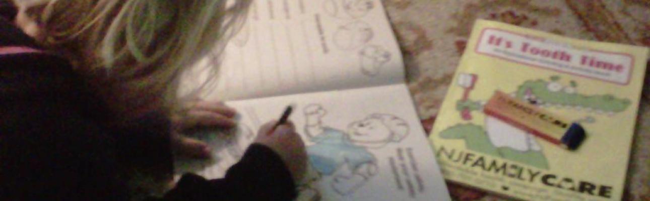 A child uses a NJ FamilyCare coloring book. ANGIE RATKOWITZ PHOTO