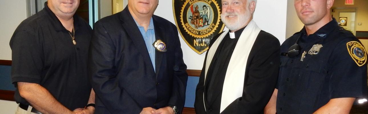 The Rev. Michael Allen with Allendale police chief Gerge Scherb and two officers