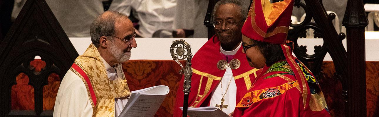 The Rt. Rev. Mark M. Beckwith, 10th Bishop of Newark, passes the diocesan crozier to the Rt. Rev. Carlye J. Hughes, newly-consecrated 11th Bishop of Newark. CYNTHIA L. BLACK PHOTO