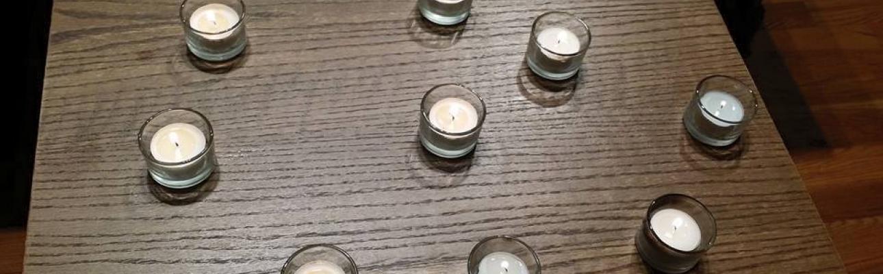 Nine votive candles representing Charleston shooting victims