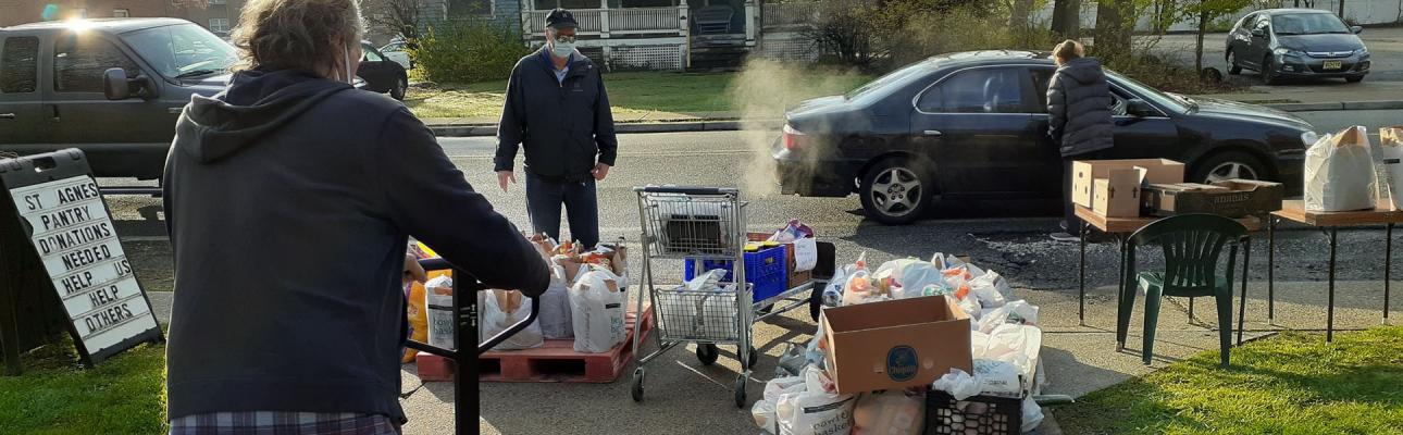 Volunteers distribute bags of food to cars lined up in front of St. Agnes, Little Falls. PHOTO COURTESY BOB DOMBROWSKI