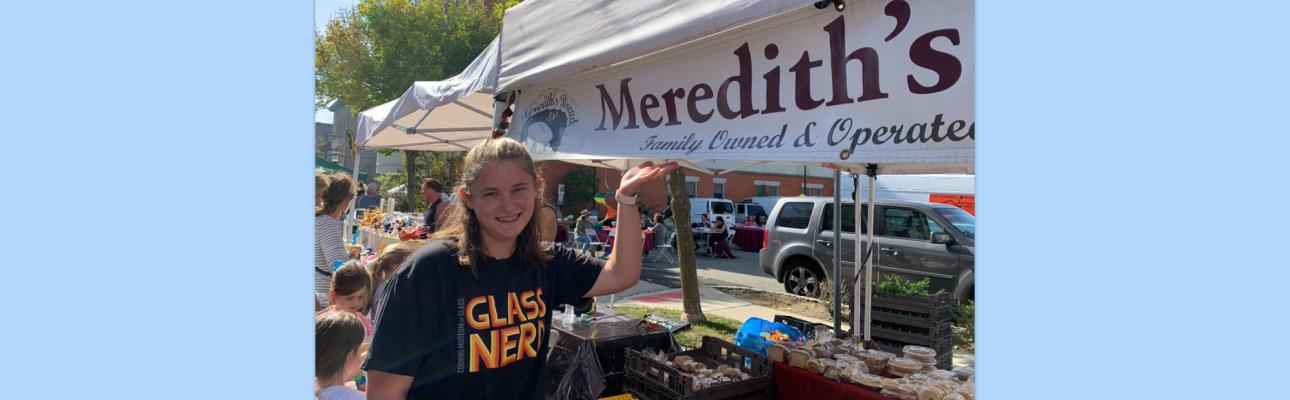 Meredith McKeever poses next to an booth that happens to bear her name. PHOTO COURTESY MEREDITH MCKEEVER