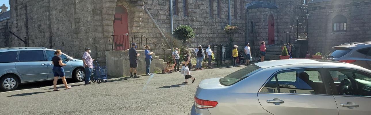 Clients line up outside the food pantry at St. Paul's, Paterson. ERIK SOLDWEDEL PHOTO