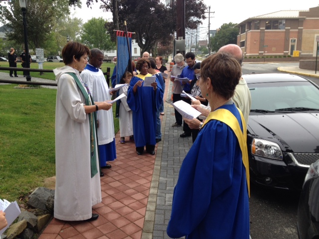 The Rev. Allison Moore, (far left) and parishioners doing a litany in procession around Good Shepherd'S property, praying for their community. GREG JACOBS PHOTO