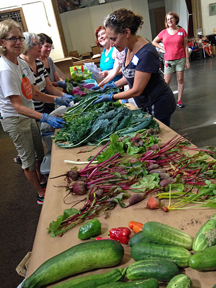 Volunteers sort fresh produce at the Interfaith Food Pantry of the Oranges