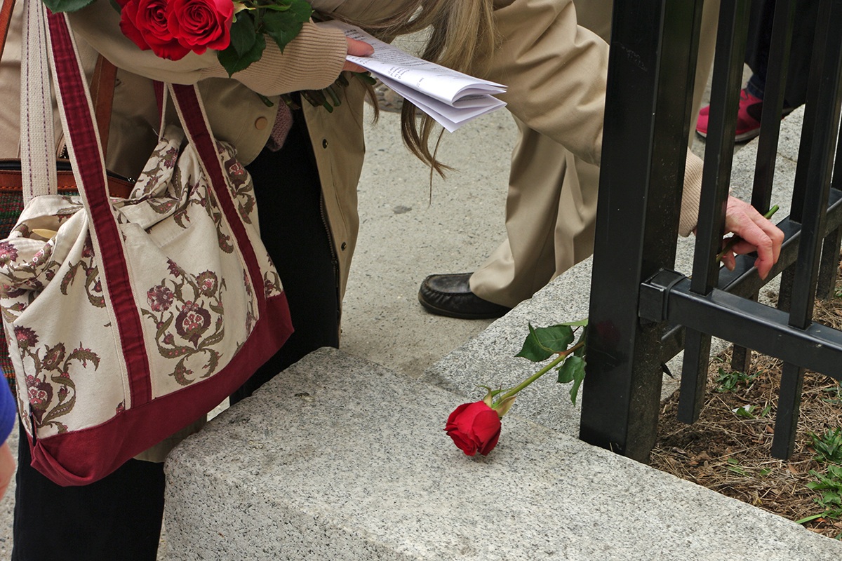 Jane Jackson of Grace Van Vorst places a rose at the first station.