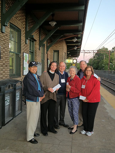 The Rev. Mary Davis, second from left, and St. Paul's members at the Chatham train station.
