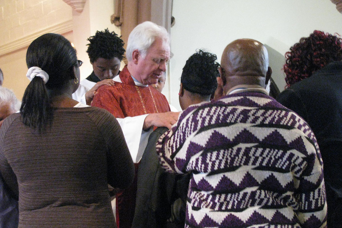 The Rev. Canon Wade Renn praying with the people at House of Prayer in Newark. PHOTO COURTESY THE REV. CANON WADE RENN