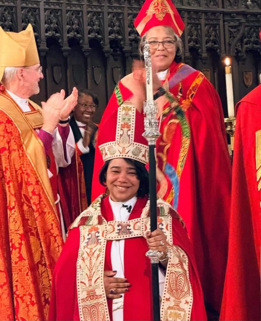 Bishop Hughes standing behind Bishop Howell